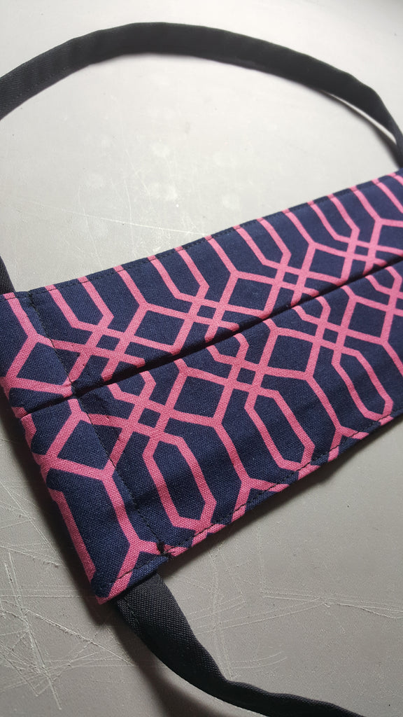 Navy blue fabric mask with a pink geometric pattern